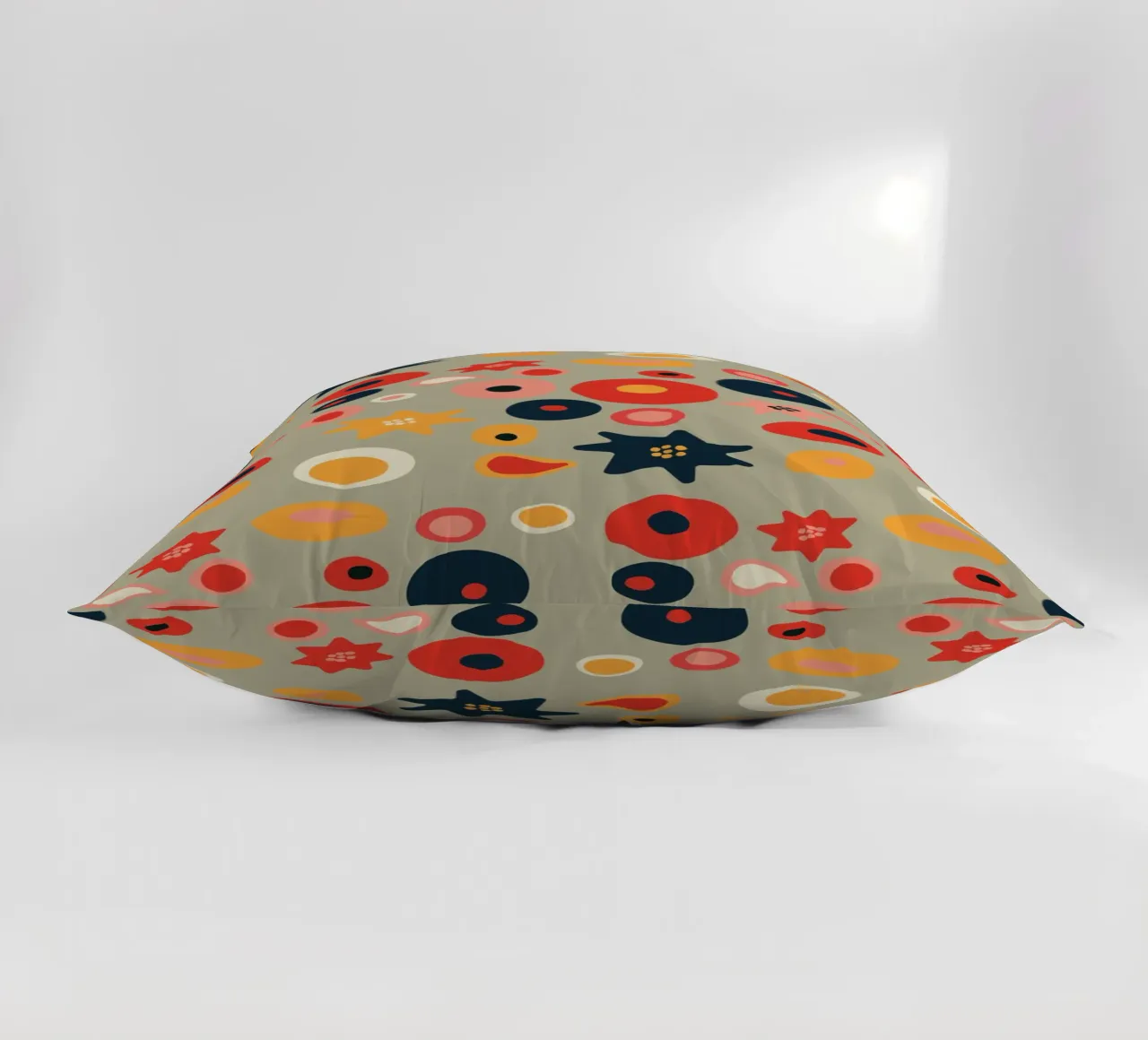 Playful flower and shape pattern in red and gold decorative cushion by Spunk