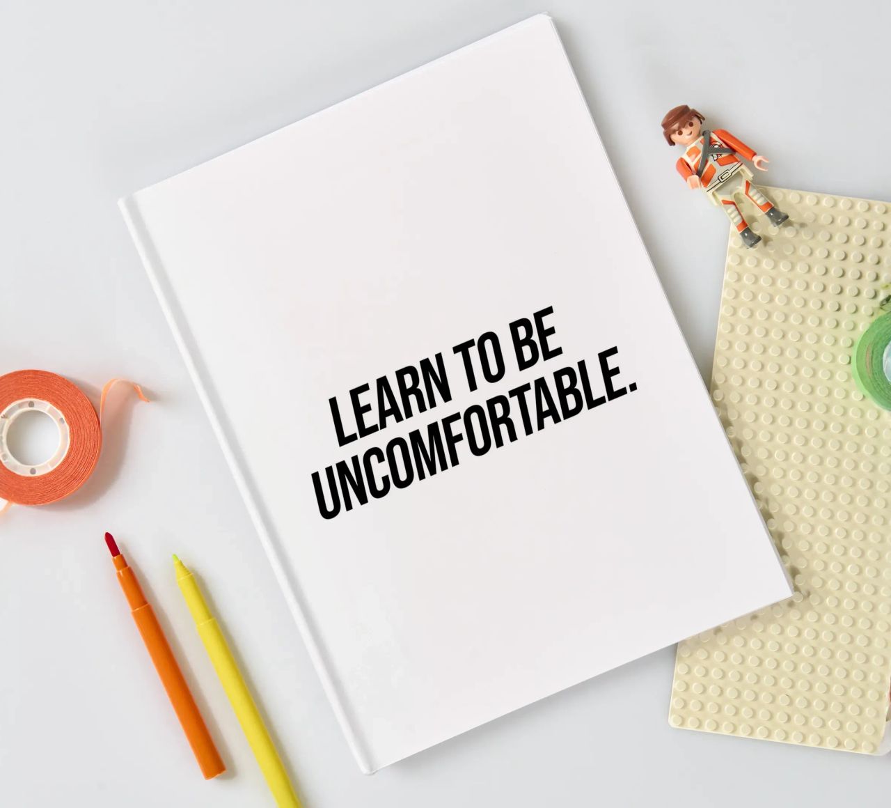Learn to be uncomfortable quote notebook by Paigaam Studio