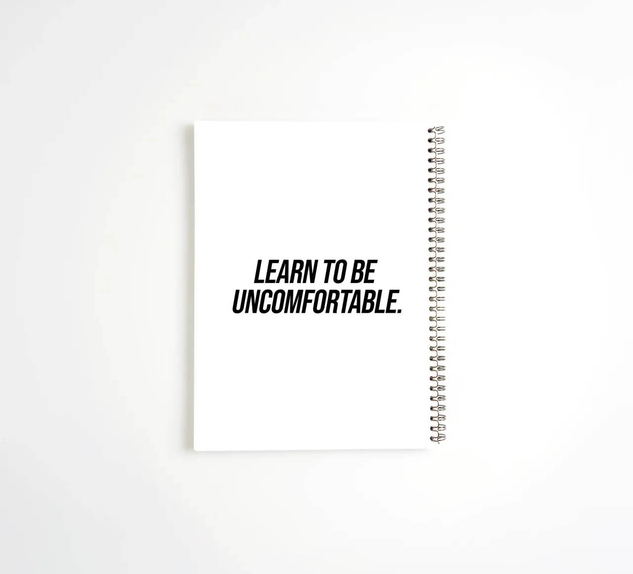 Learn to be uncomfortable quote spiral notebook by Paigaam Studio