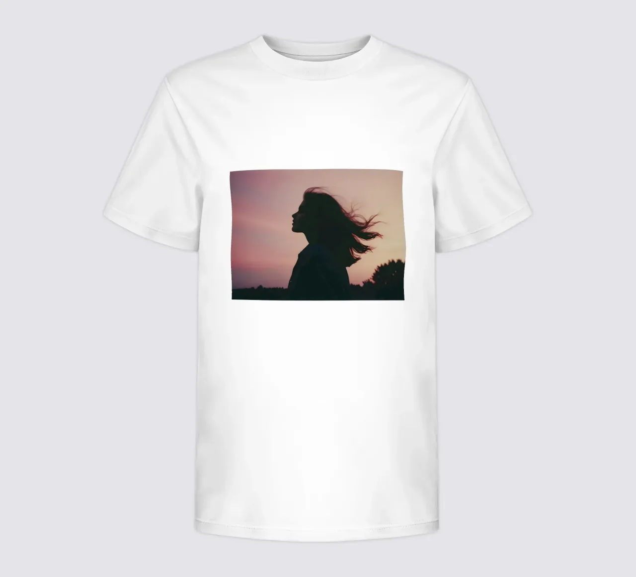 silhouette of a girl with her hair flowing in the wind kids t-shirt by serinae