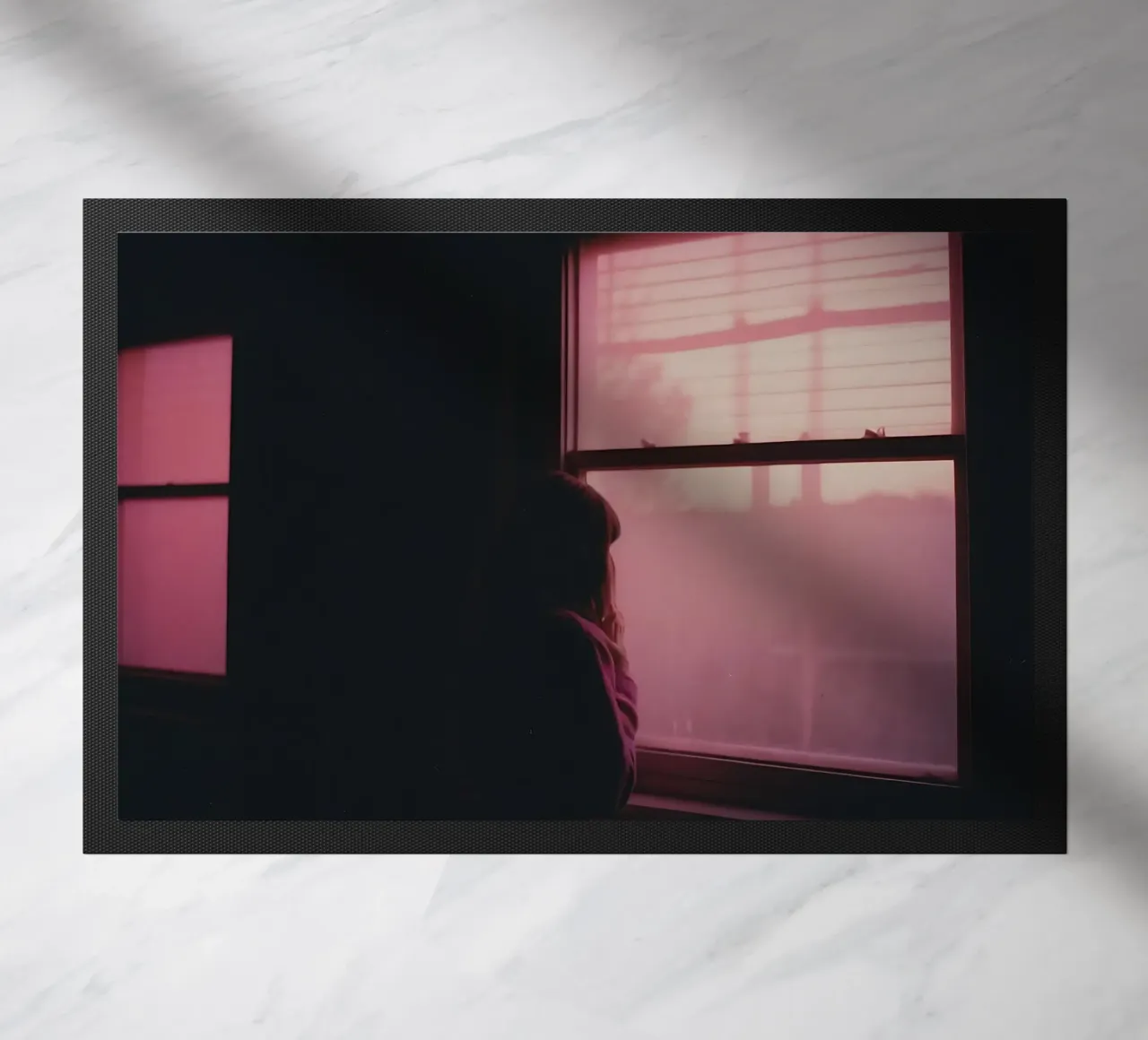 silhouette of a girl looking out the window in a dim room doormat by serinae