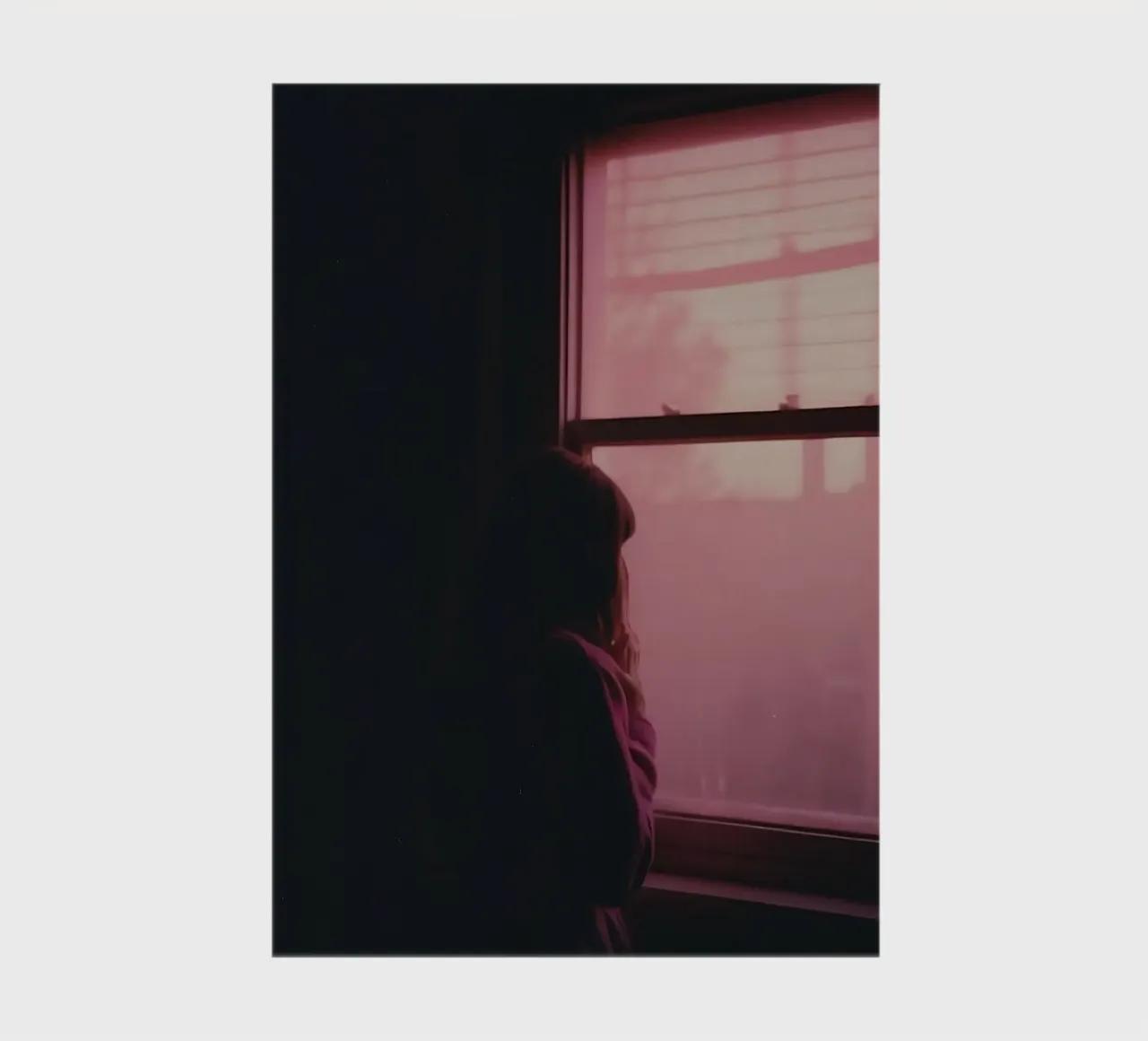 silhouette of a girl looking out the window in a dim room notebook by serinae