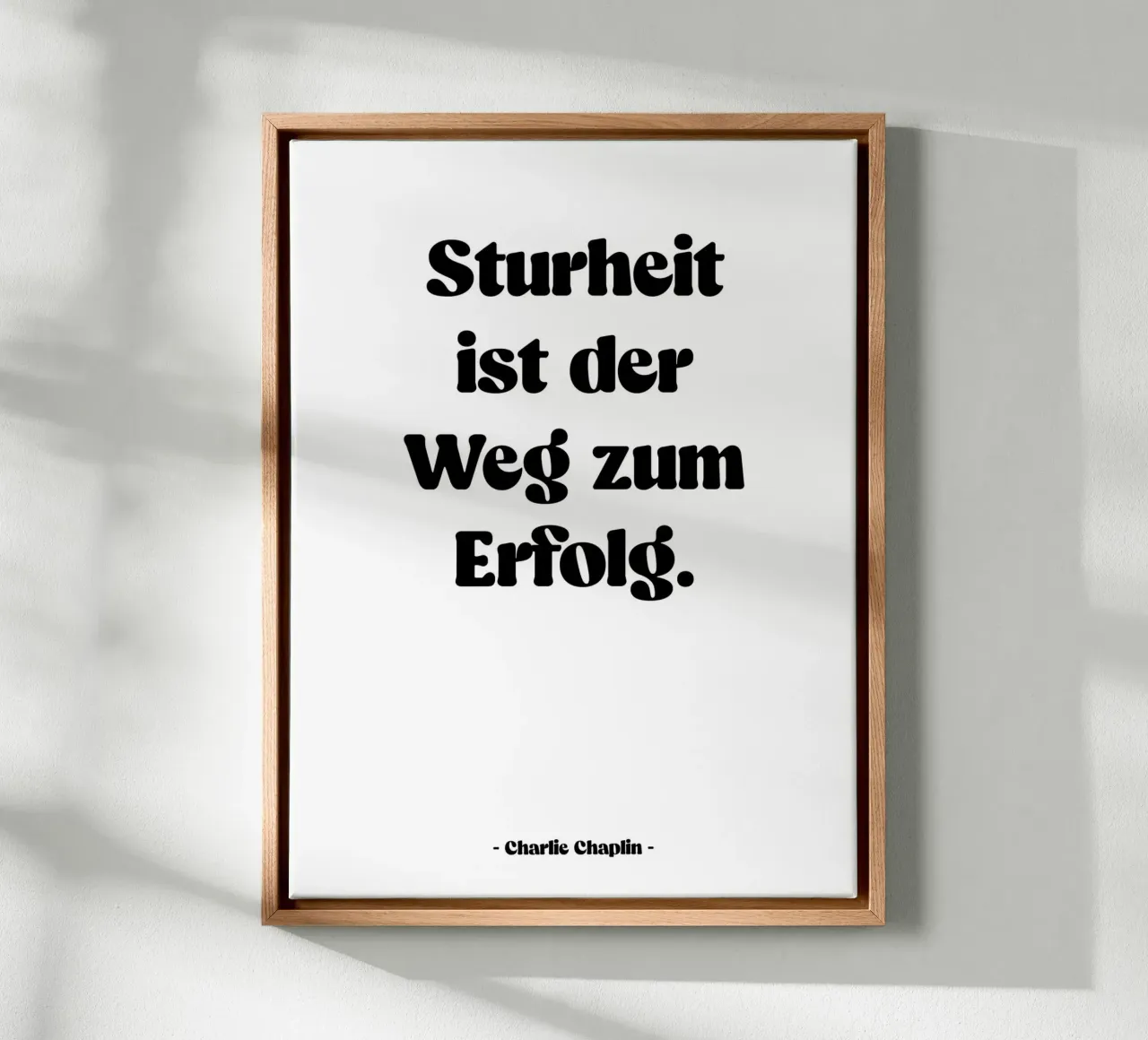Citation "Stubbornness is the path to success" canvas with Floater frame by Wall of Words