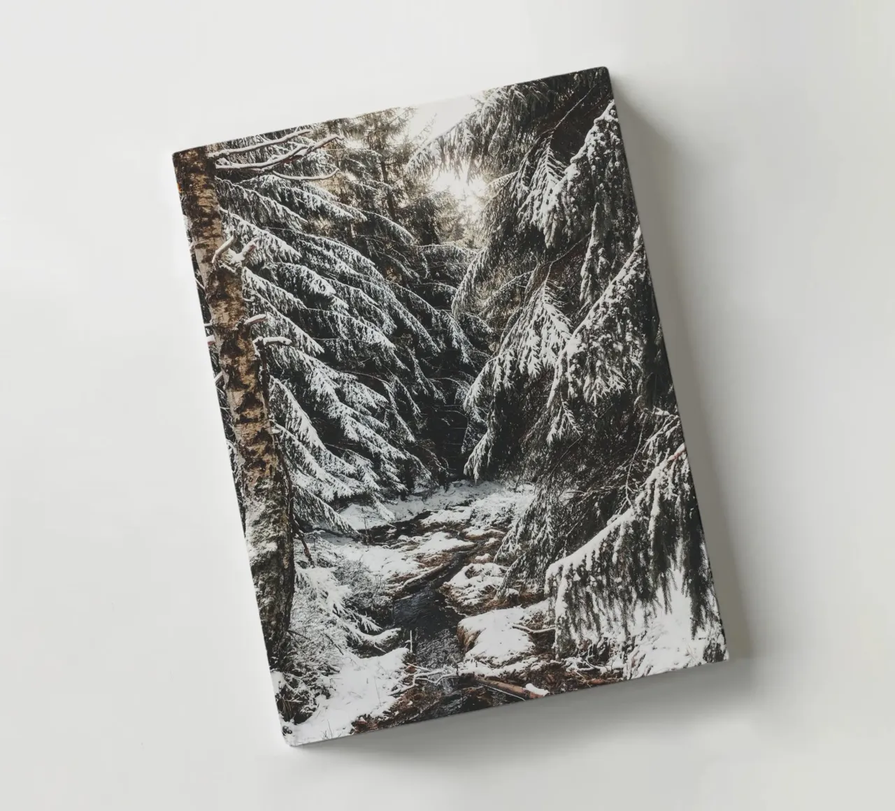 Enchanting winter forest with stream and snow-covered trees notebook by Bold and Retro