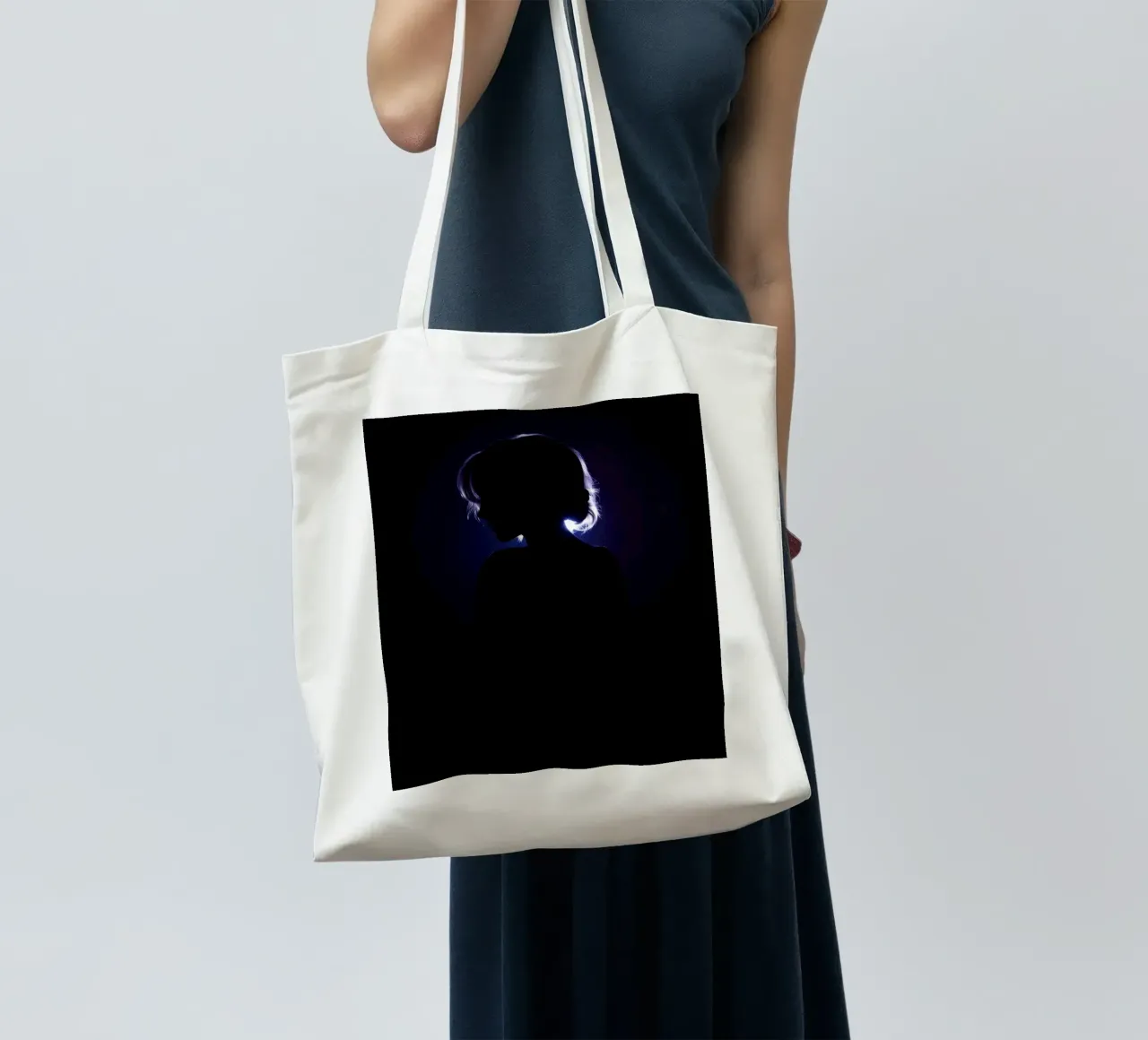 Silhouette of a child against a dark background illuminated tote bag by DesignDoodle