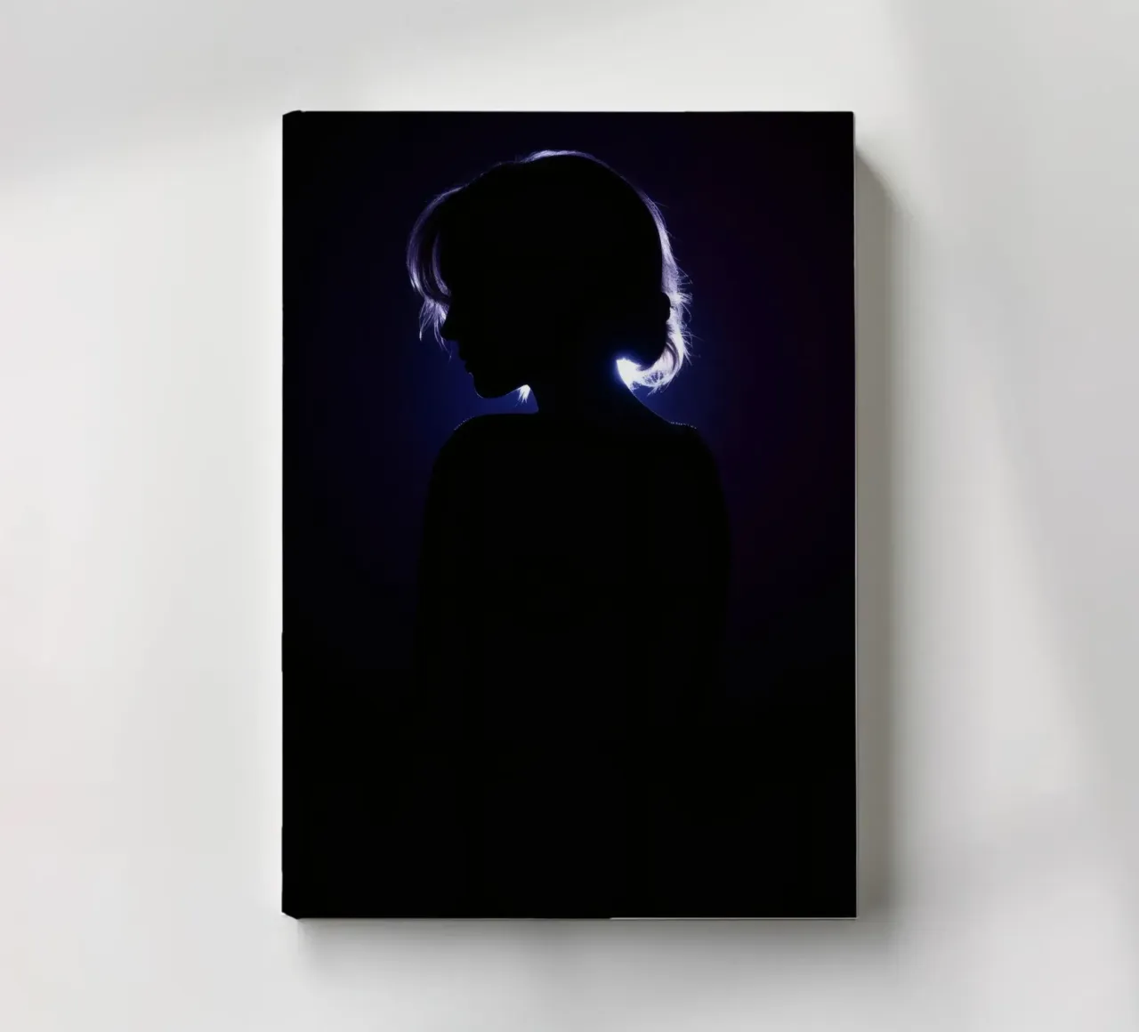 Silhouette of a child against a dark background illuminated notebook by DesignDoodle