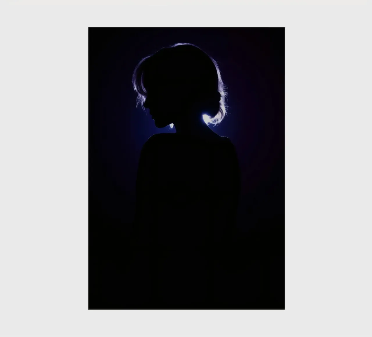 Silhouette of a child against a dark background illuminated notebook by DesignDoodle