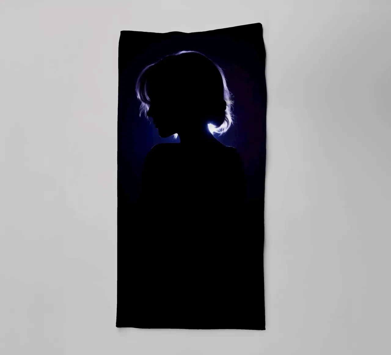 Silhouette of a child against a dark background illuminated towel by DesignDoodle