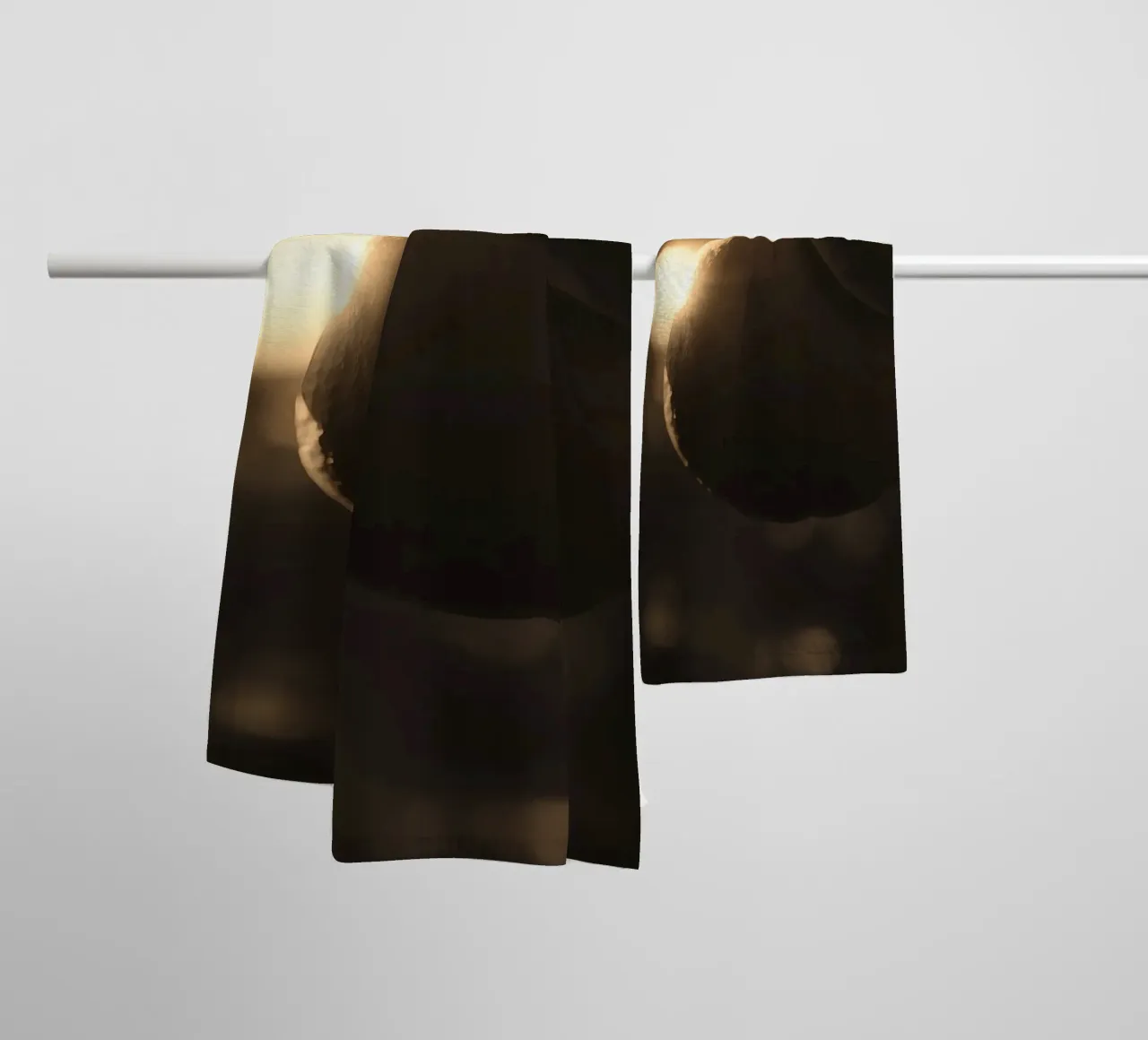 Sunlight filters through leaves highlighting a single orange towel by DesignDoodle