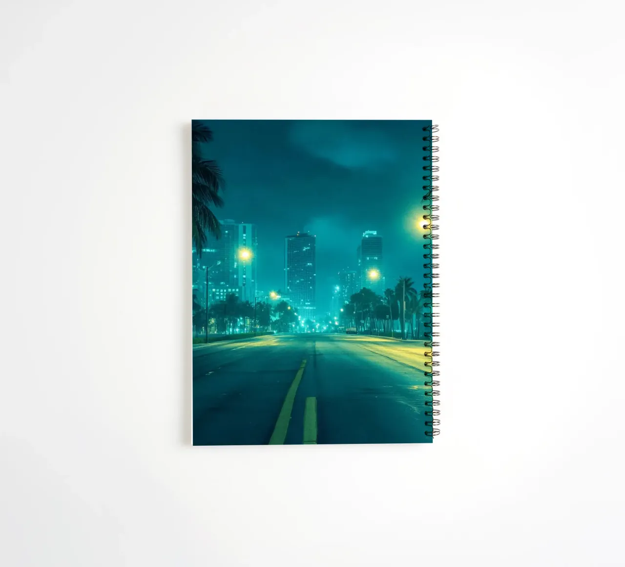 Miami by night: palm trees and the illuminated skyline spiral notebook by By Night