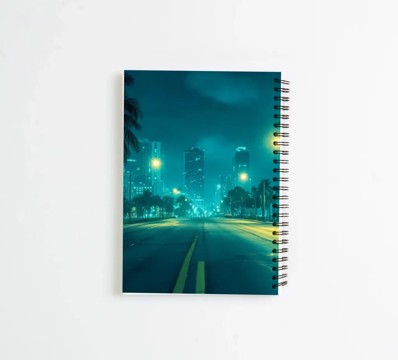 Miami by night: palm trees and the illuminated skyline spiral notebook by By Night