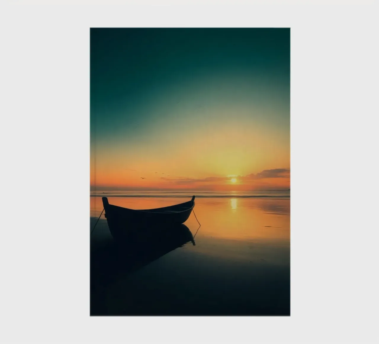 Silhouetted boat resting on calm water at sunset with vibran notebook by DesignDoodle