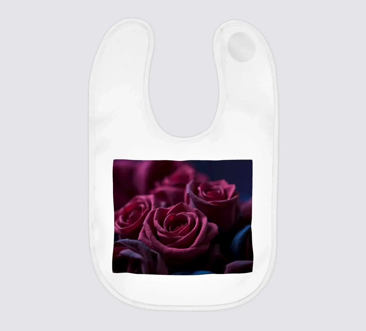 Bouquets of deep red roses arranged artfully in low light baby bib by DesignDoodle