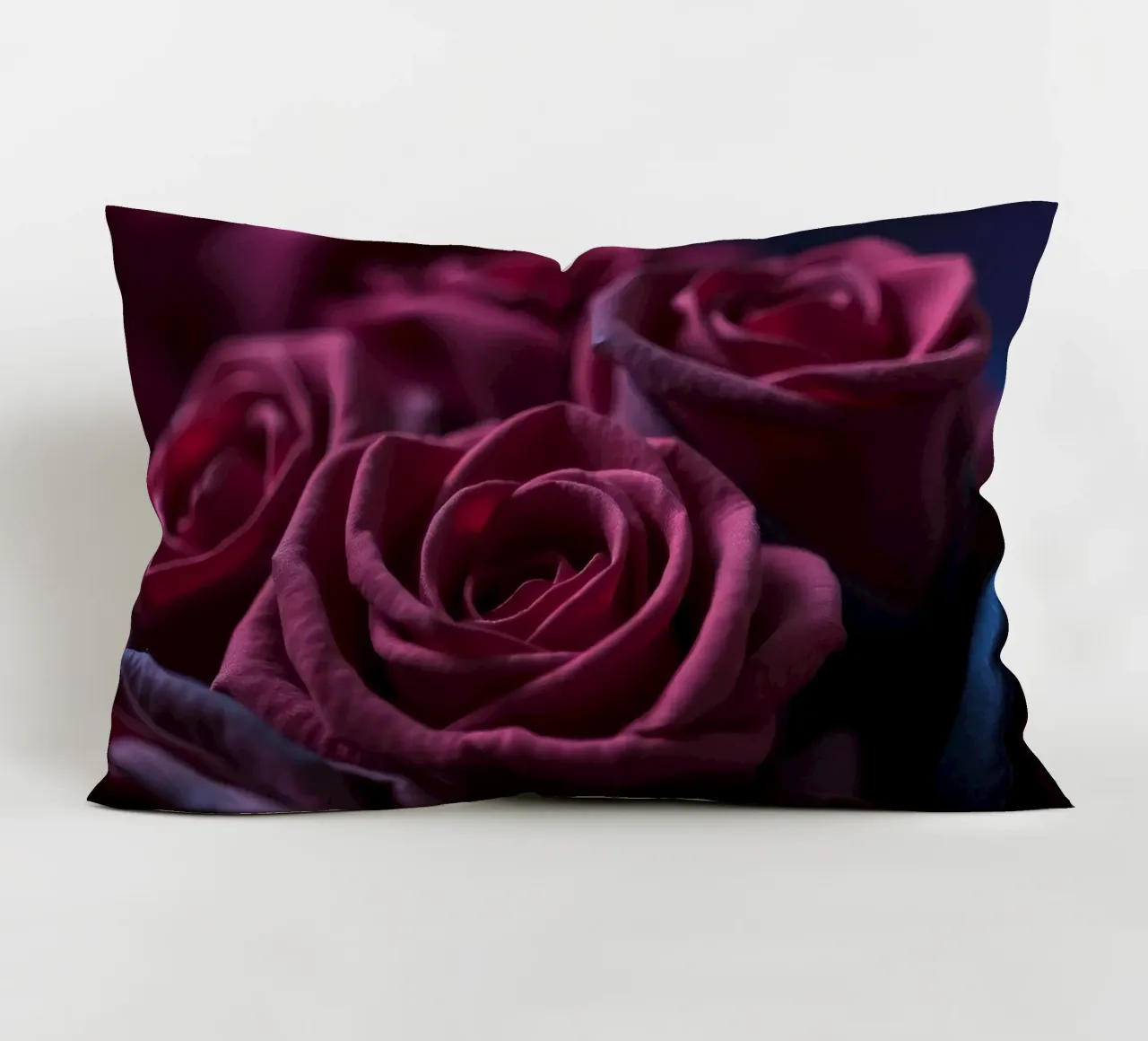 Bouquets of deep red roses arranged artfully in low light decorative cushion by DesignDoodle