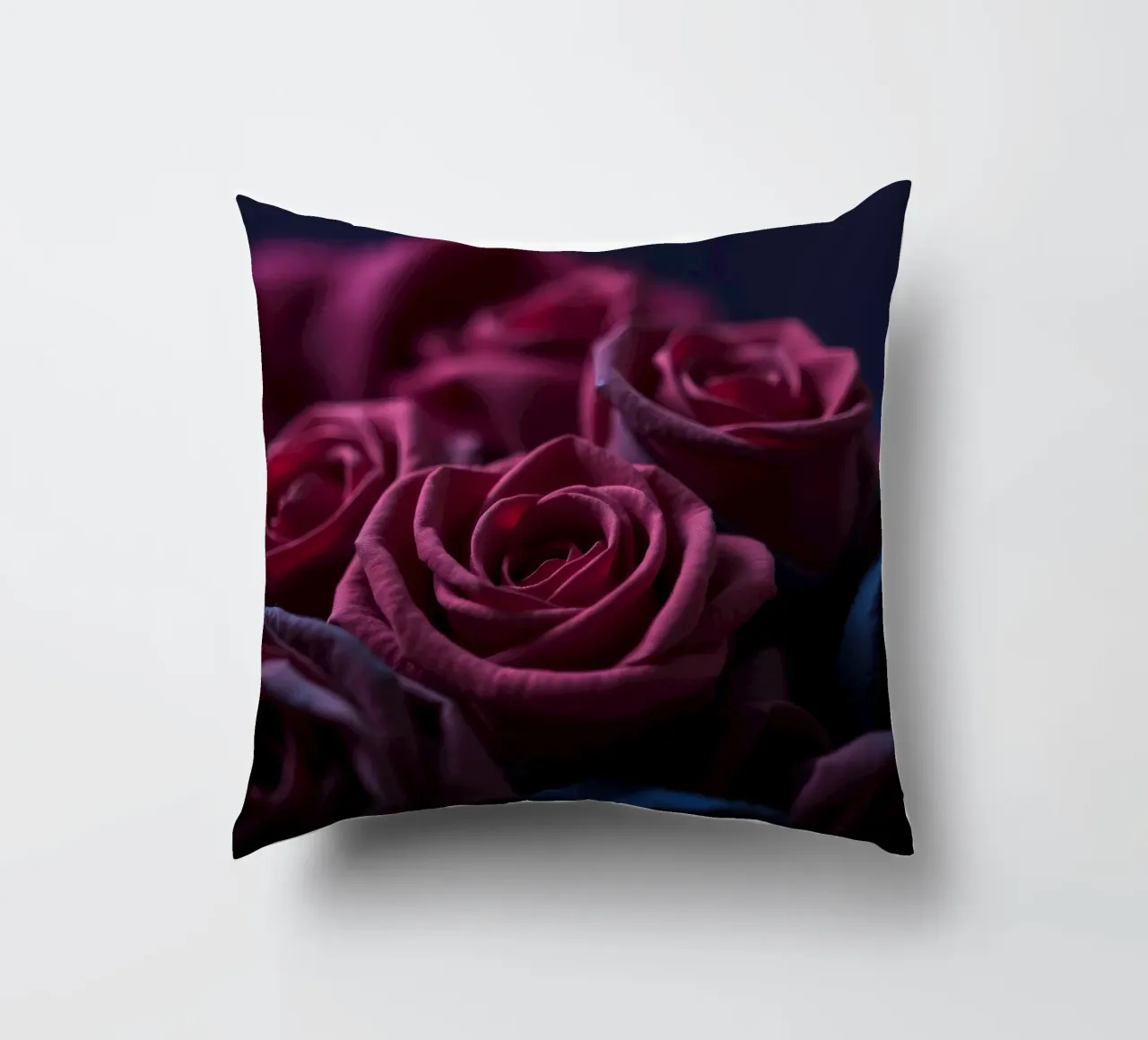 Bouquets of deep red roses arranged artfully in low light decorative cushion by DesignDoodle