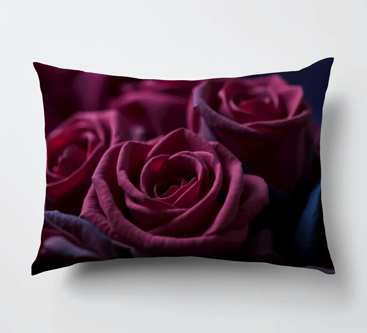 Bouquets of deep red roses arranged artfully in low light decorative cushion by DesignDoodle
