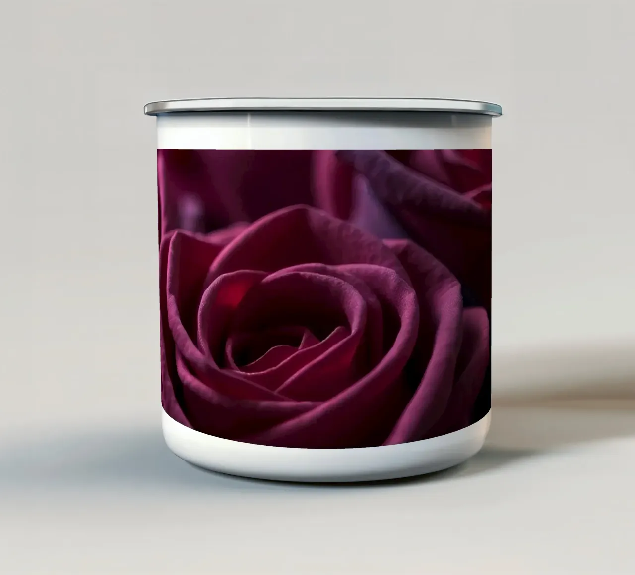 Bouquets of deep red roses arranged artfully in low light enamel mug by DesignDoodle