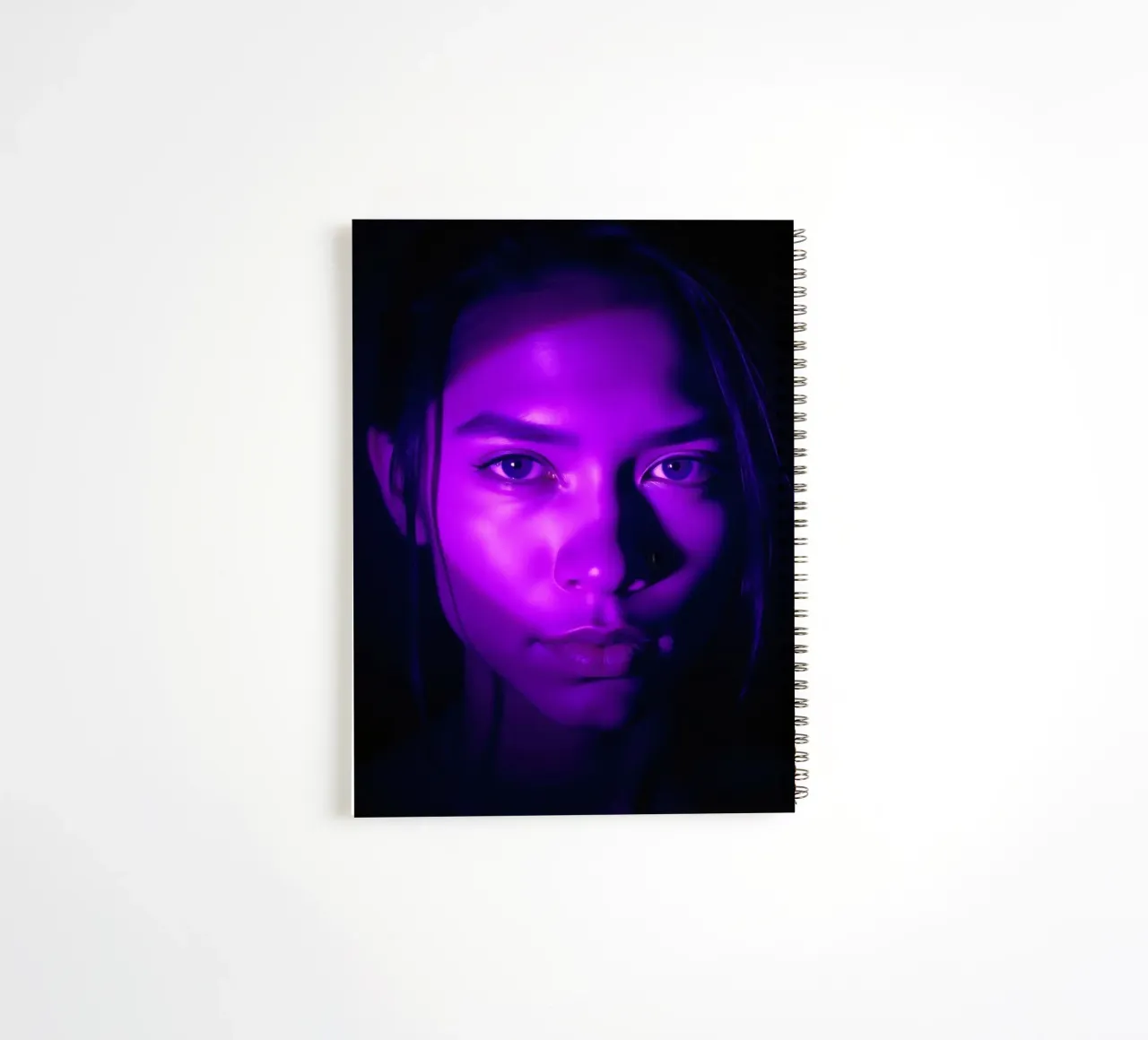 Striking portrait with purple lighting highlighting facial spiral notebook by DesignDoodle