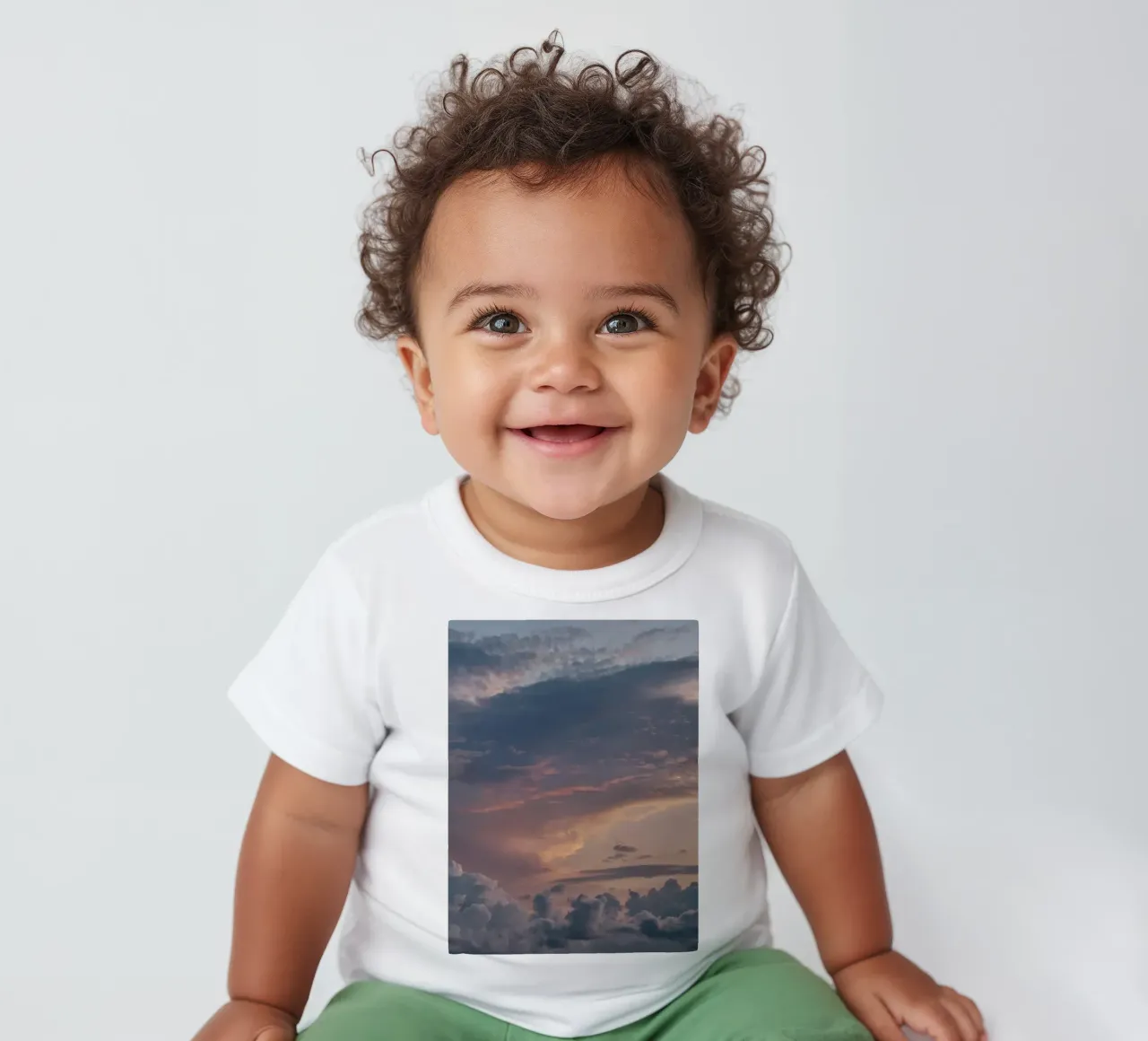 Vibrant sunset over layered clouds in a peaceful sky at dusk baby t-shirt by DesignDoodle