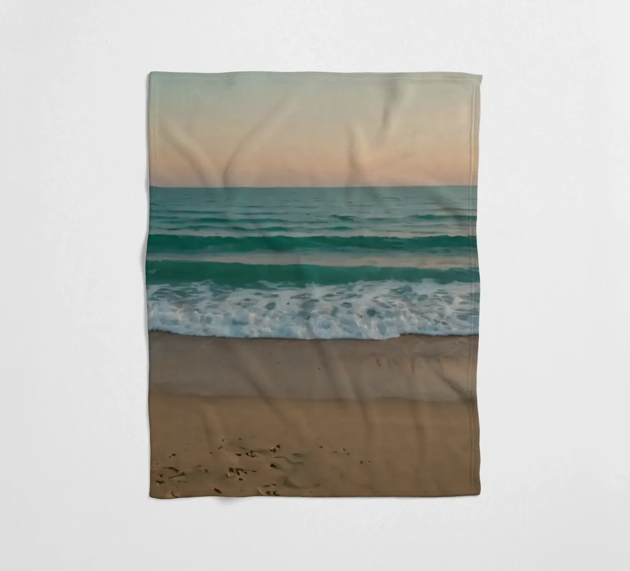 Soft waves lap against golden sand under a colorful sky fleece blanket by DesignDoodle