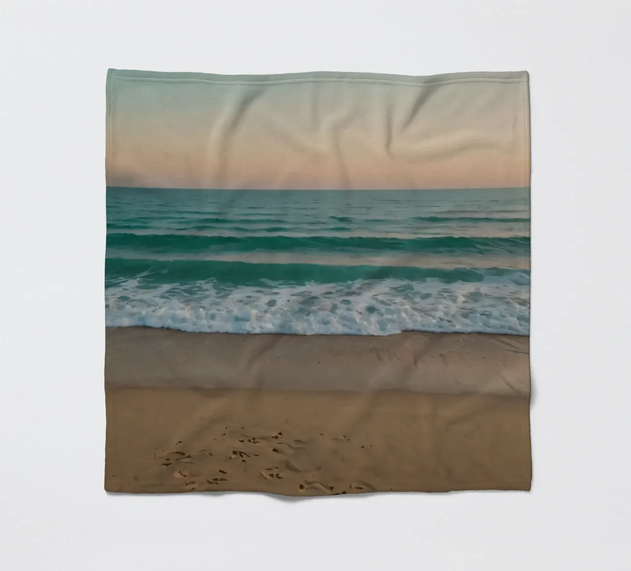 Soft waves lap against golden sand under a colorful sky fleece blanket by DesignDoodle
