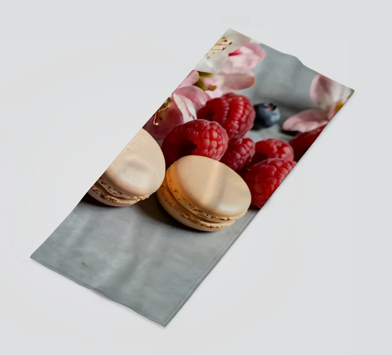 Freshly made macarons surrounded by vibrant berries beach towel by DesignDoodle