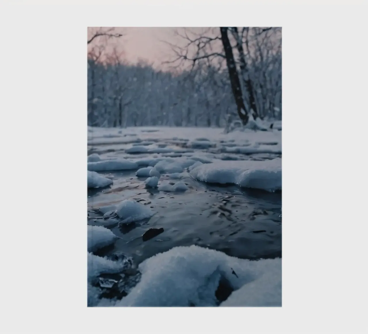 Serene winter landscape with flowing water surrounded snow notebook by DesignDoodle