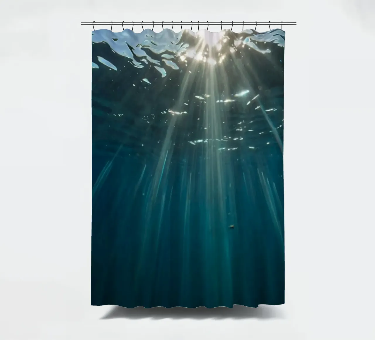 Rays of sunlight penetrate clear water creating shower curtain by DesignDoodle