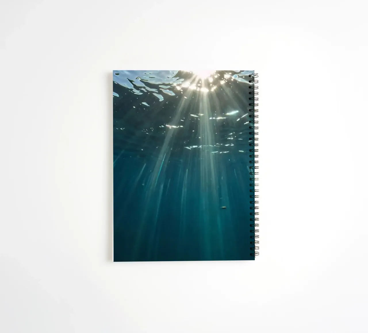 Rays of sunlight penetrate clear water creating spiral notebook by DesignDoodle