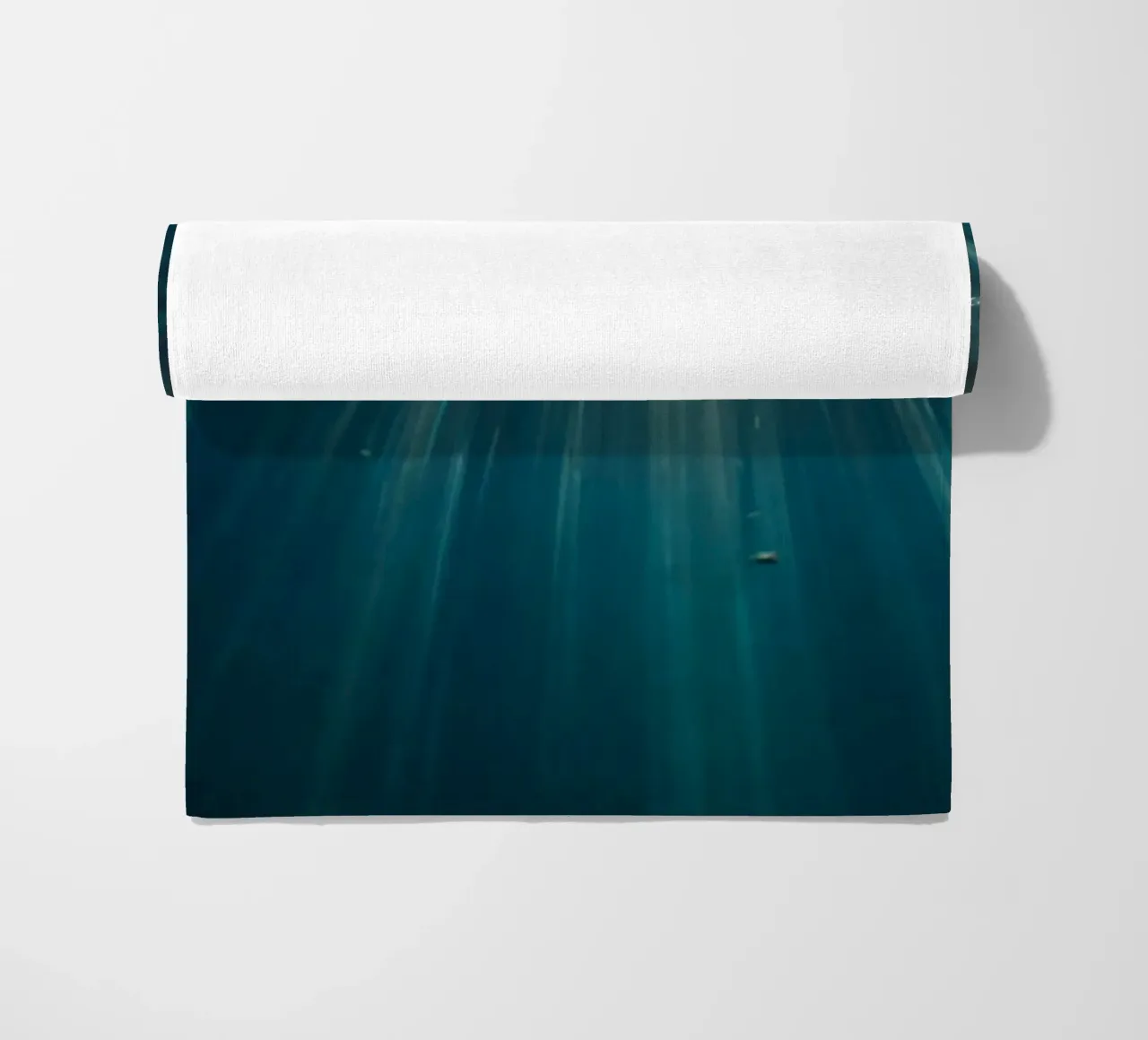 Rays of sunlight penetrate clear water creating beach towel by DesignDoodle