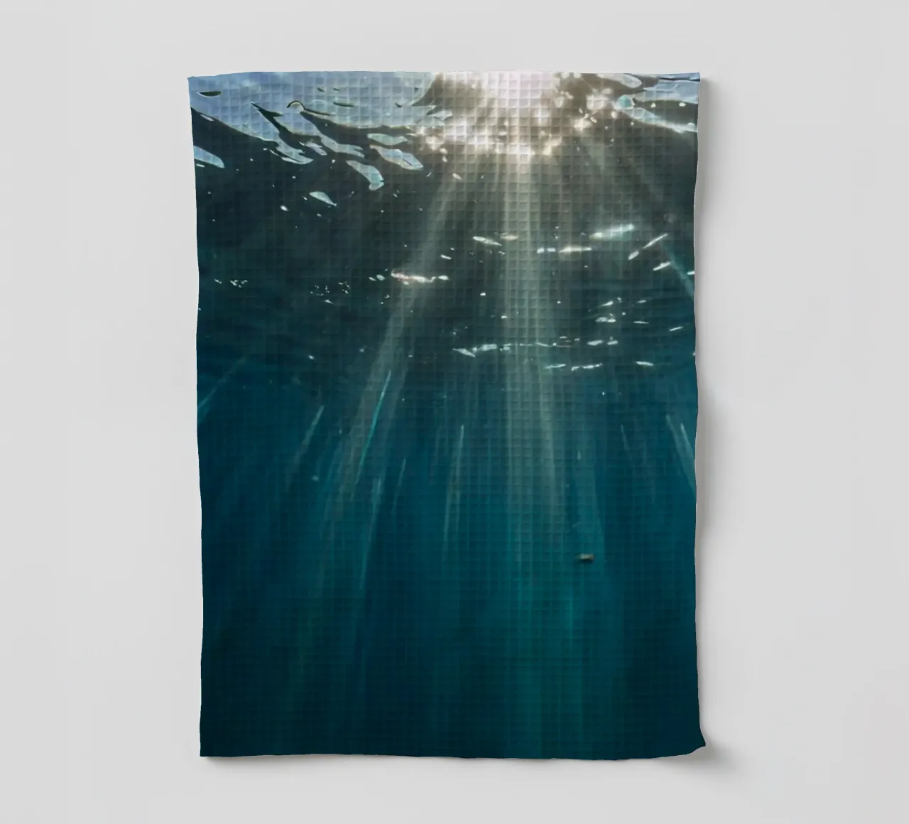 Rays of sunlight penetrate clear water creating tea towel by DesignDoodle