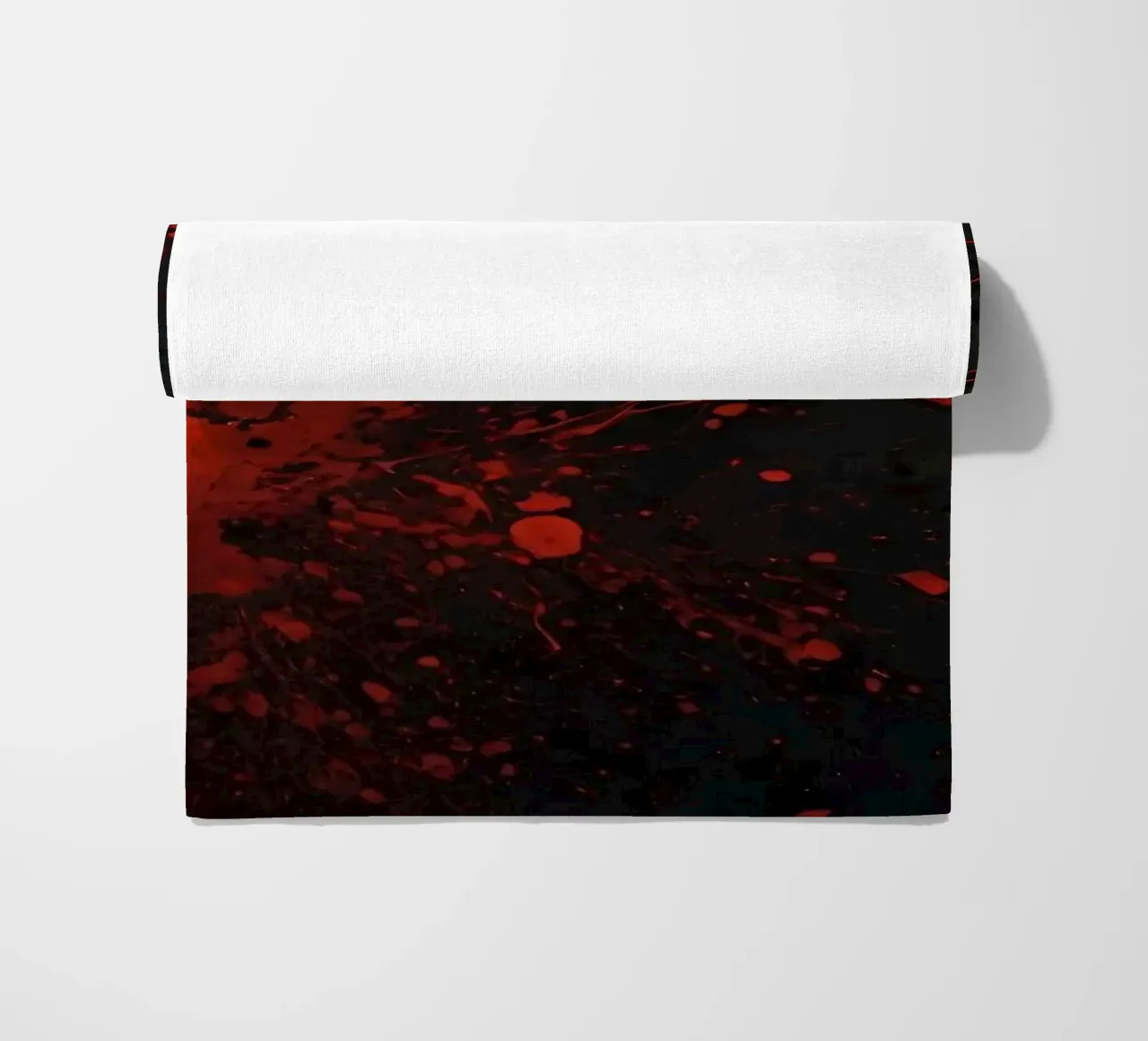 Bold red paint splatters on a dark textured background beach towel by DesignDoodle