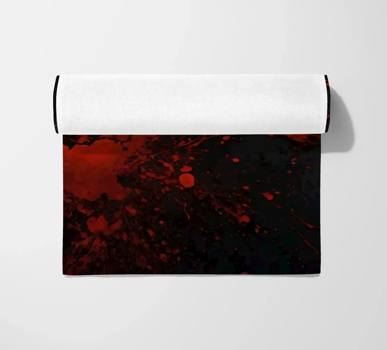 Bold red paint splatters on a dark textured background beach towel by DesignDoodle