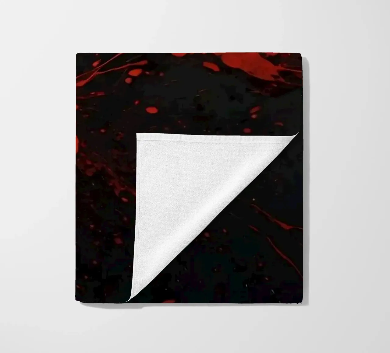 Bold red paint splatters on a dark textured background beach towel by DesignDoodle