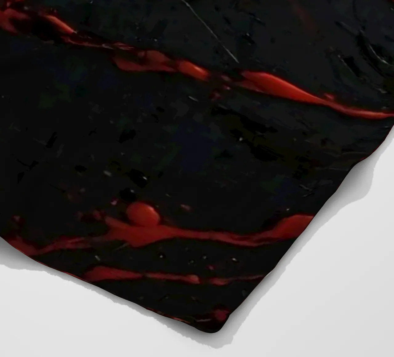 Abstract red paint splatters on a black surface fleece blanket by DesignDoodle