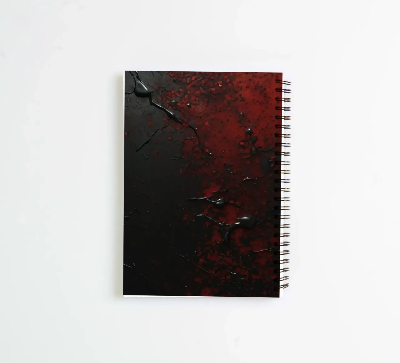 Abstract texture with black and red paint splashes on a dark spiral notebook by DesignDoodle