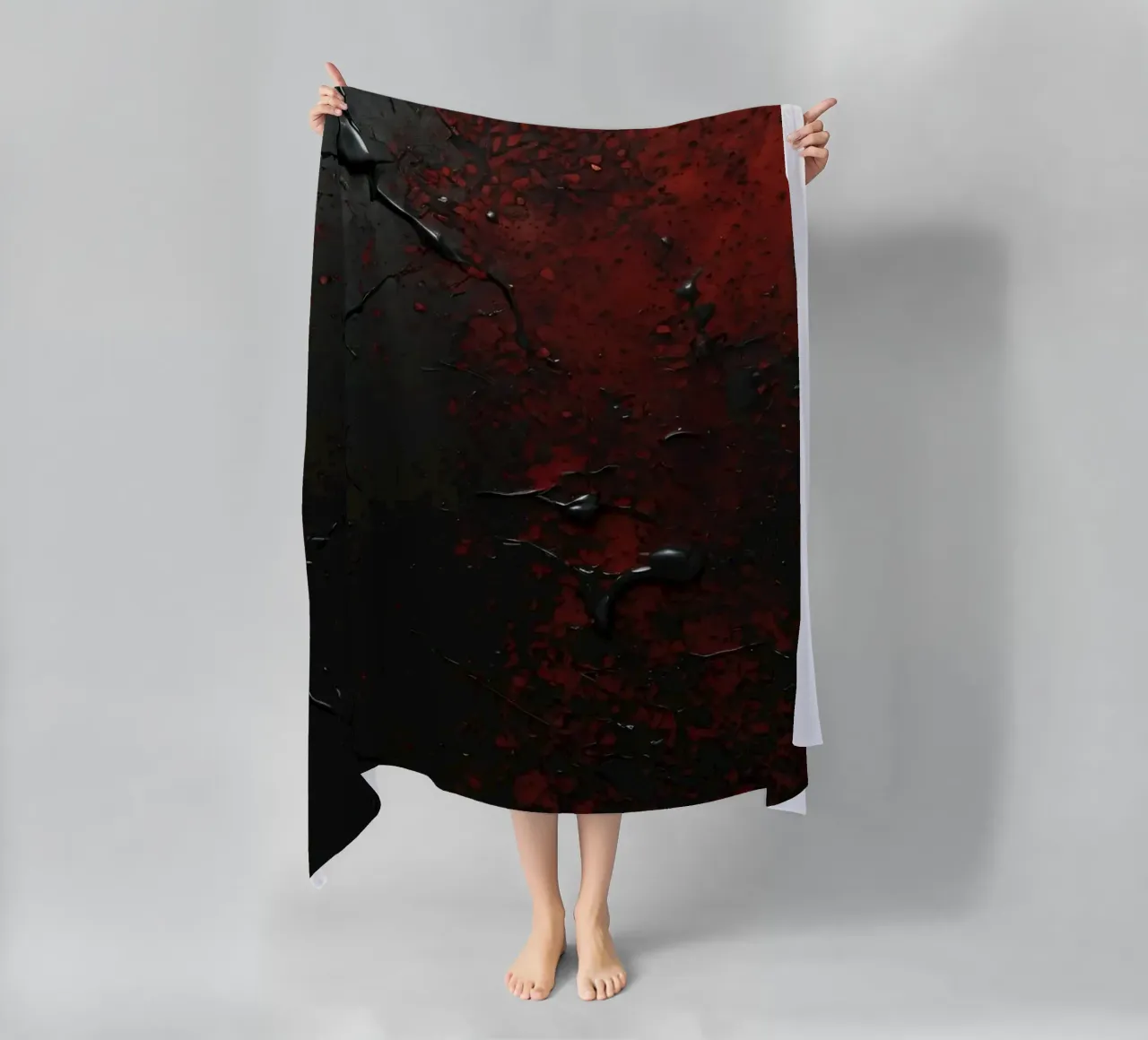 Abstract texture with black and red paint splashes on a dark beach towel by DesignDoodle