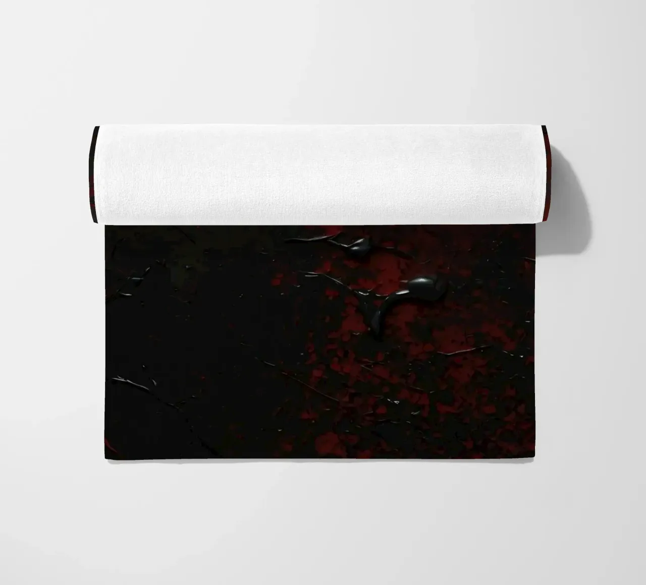 Abstract texture with black and red paint splashes on a dark beach towel by DesignDoodle
