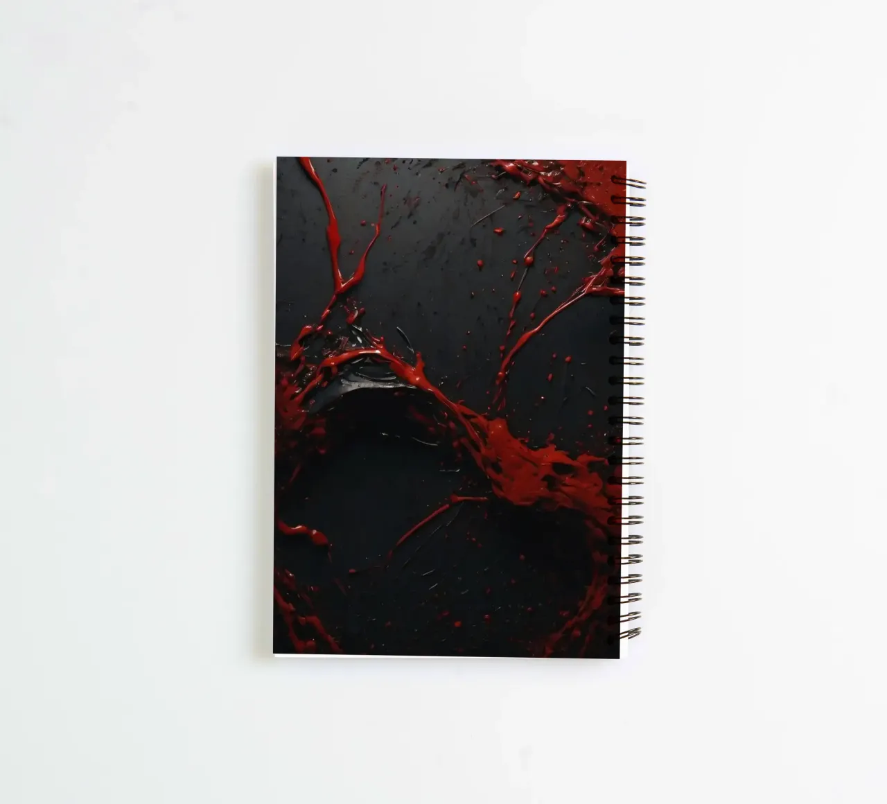Vivid red paint splatter creates abstract design a dark spiral notebook by DesignDoodle
