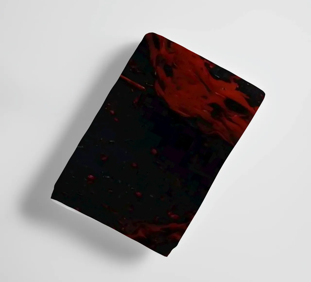 Vivid red paint splatter creates abstract design a dark towel by DesignDoodle