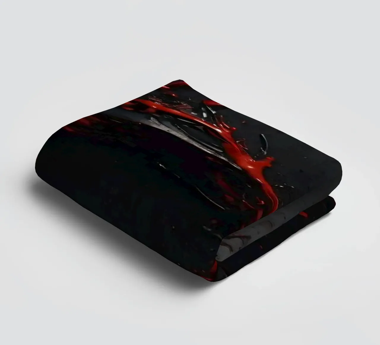Vivid red paint splatter creates abstract design a dark towel by DesignDoodle