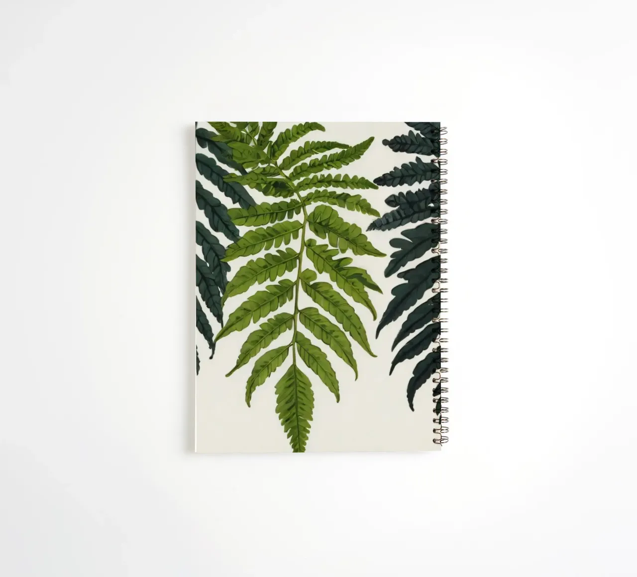 Vibrant green ferns displayed artfully against neutral spiral notebook by DesignDoodle
