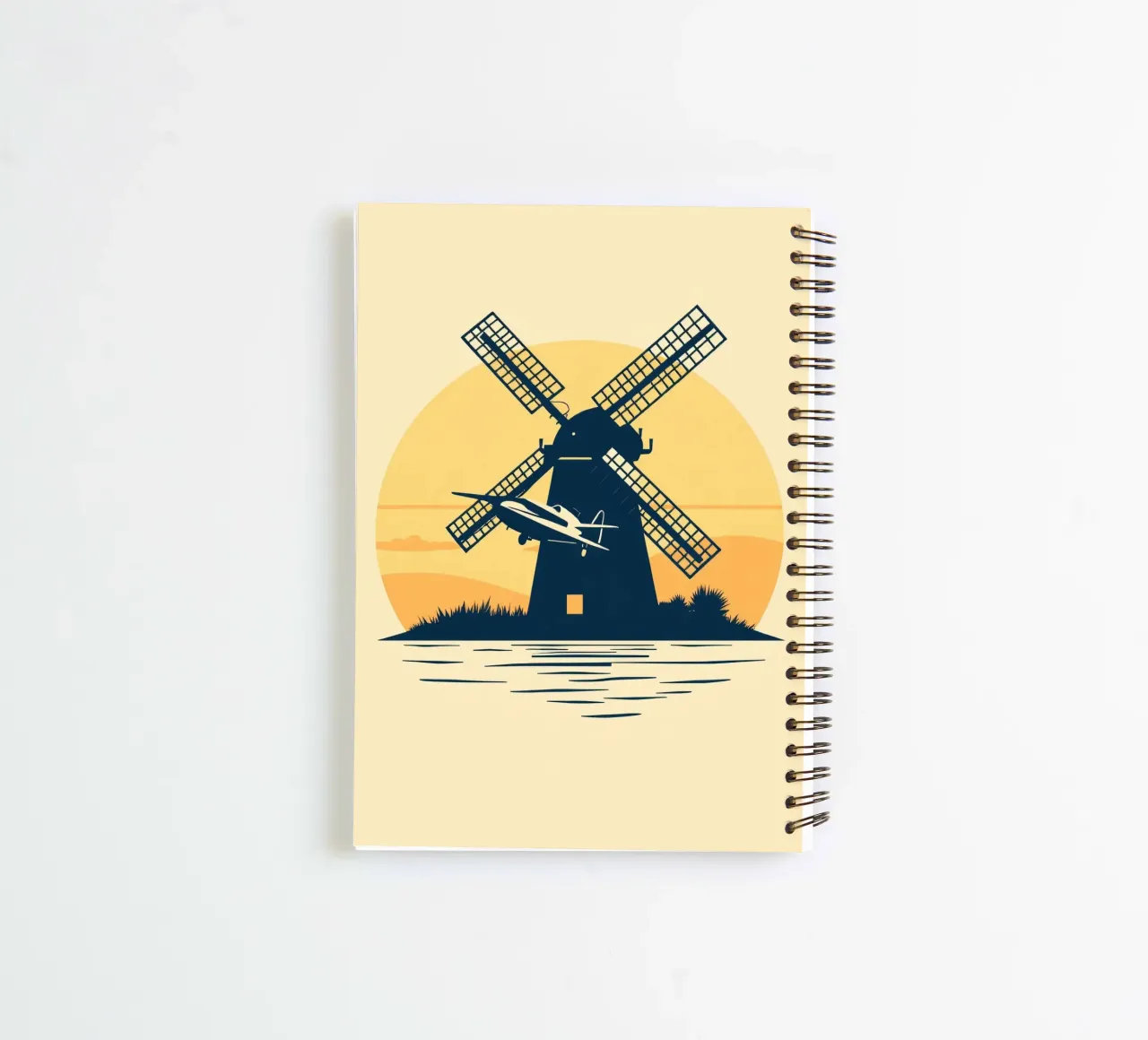 La silhouette di un mulino a vento al tramonto con un aereo in volo diario ad anelli da DesignDoodle