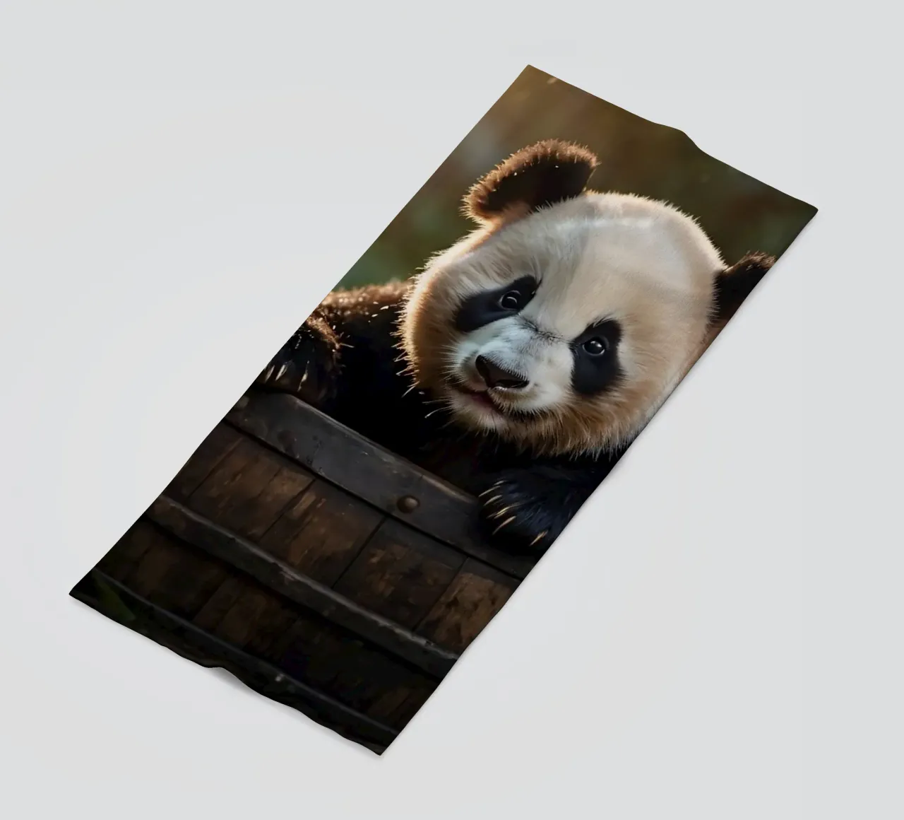 Un cucciolo di panda gioca a esplorare un barile di legno in una stanza illuminata dal sole. telo mare da DesignDoodle
