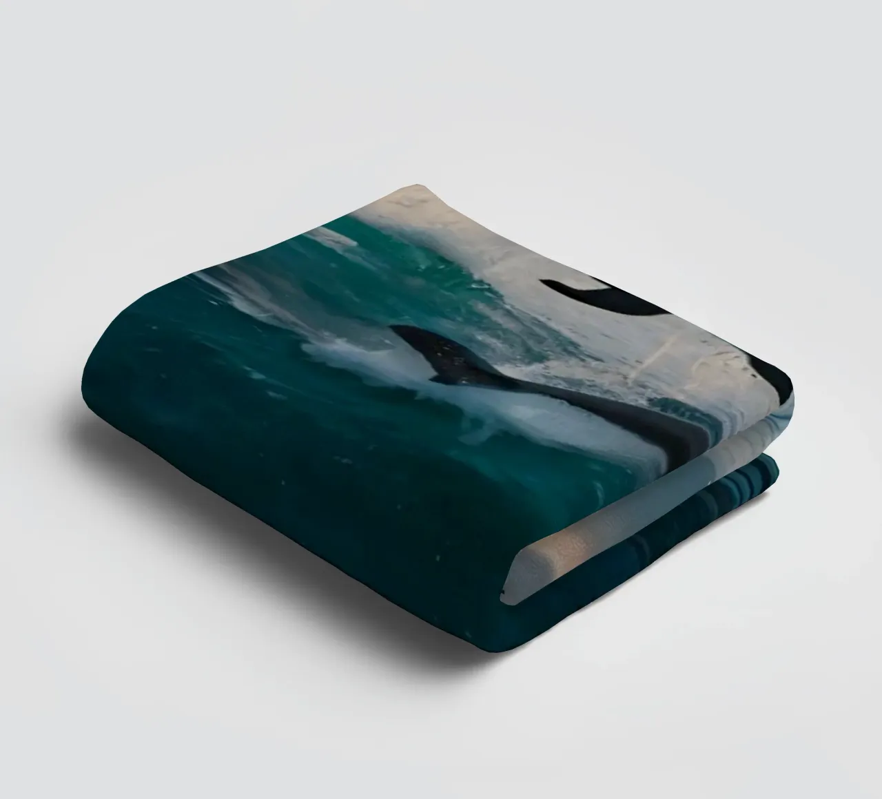 Dolphins leap gracefully above ocean waves at sunset towel by DesignDoodle