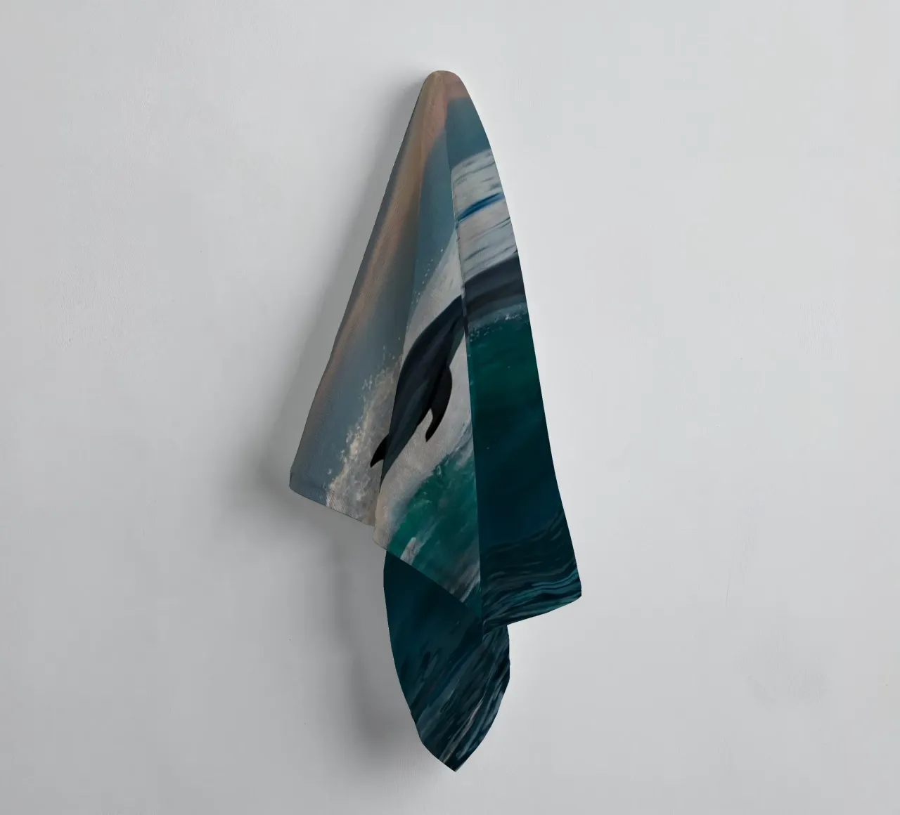 Dolphins leap gracefully above ocean waves at sunset towel by DesignDoodle