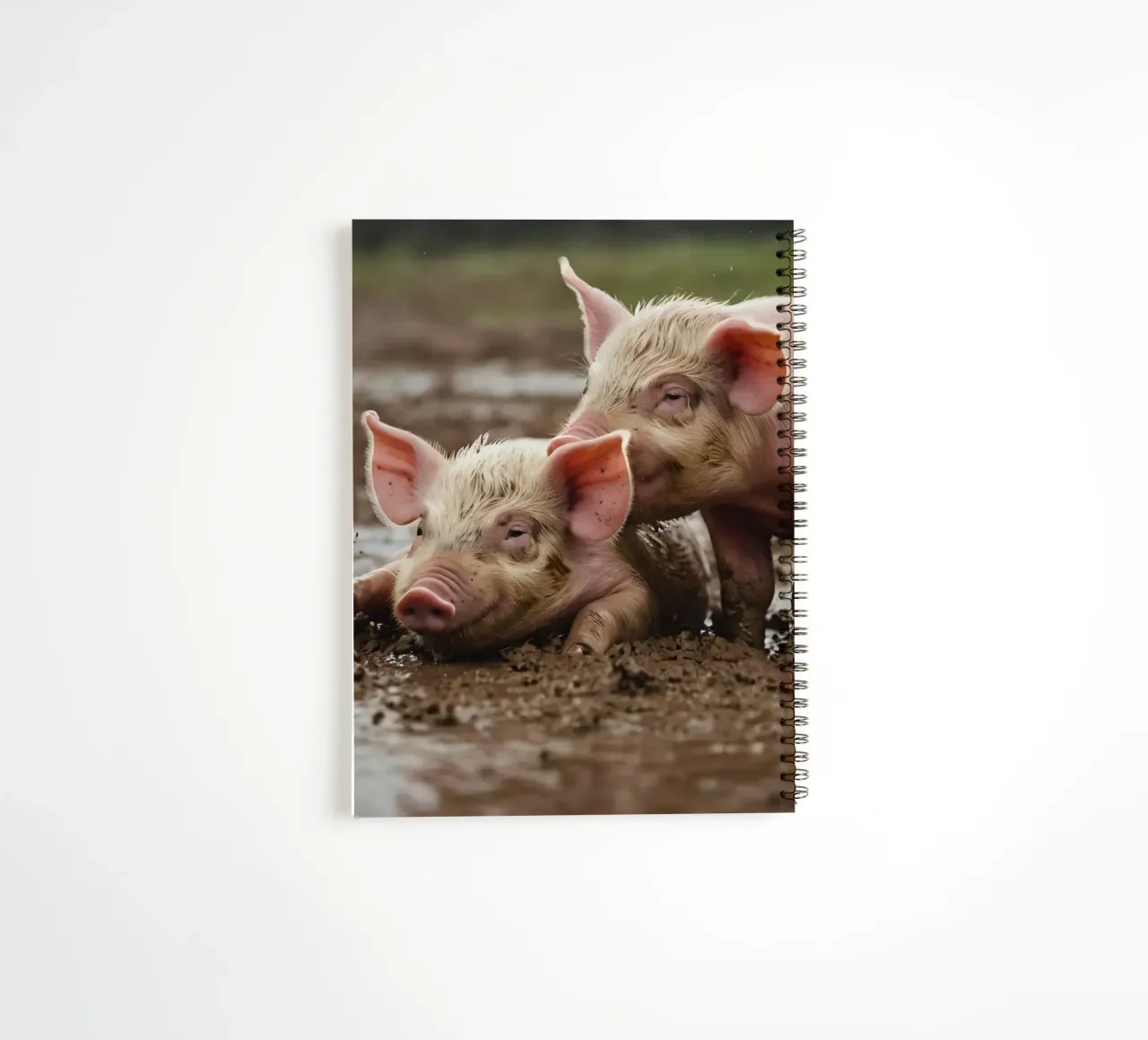 Two playful piglets enjoying muddy ground on a farm spiral notebook by DesignDoodle