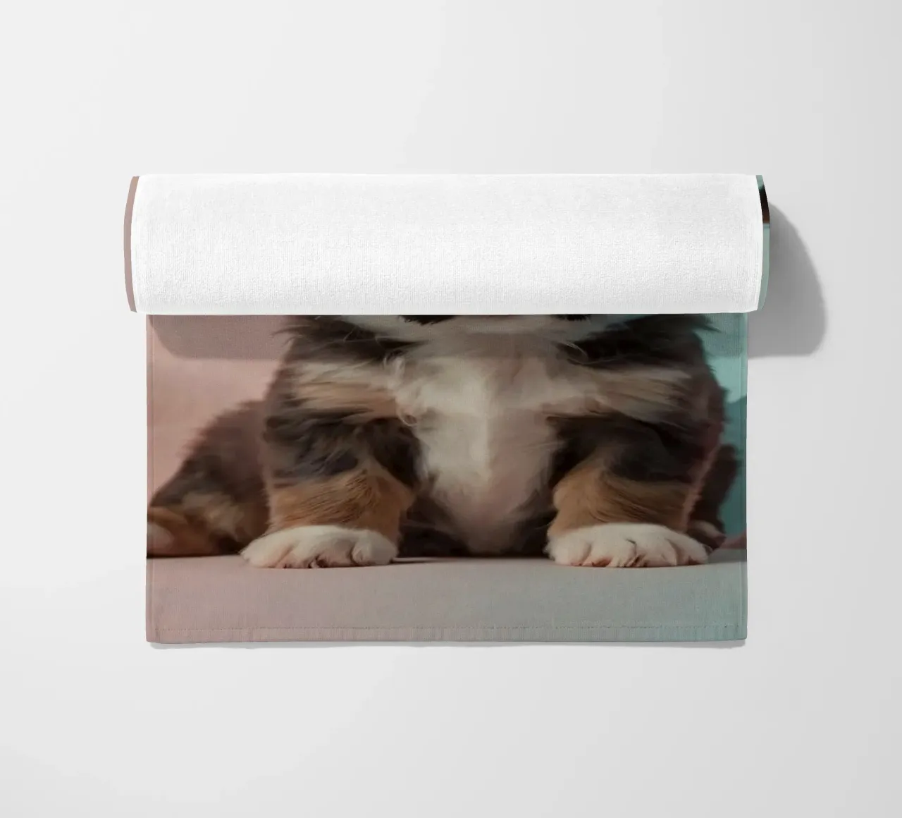Cute puppy sitting between pastel-colored rocks beach towel by DesignDoodle