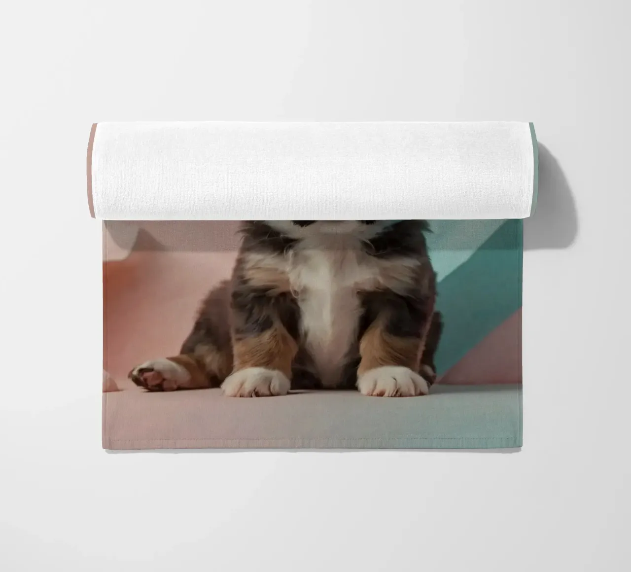 Cute puppy sitting between pastel-colored rocks beach towel by DesignDoodle