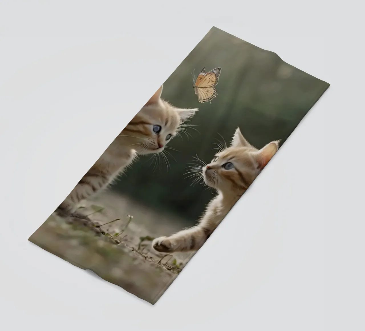 Two playful kittens chase butterflies in a sunlit garden beach towel by DesignDoodle